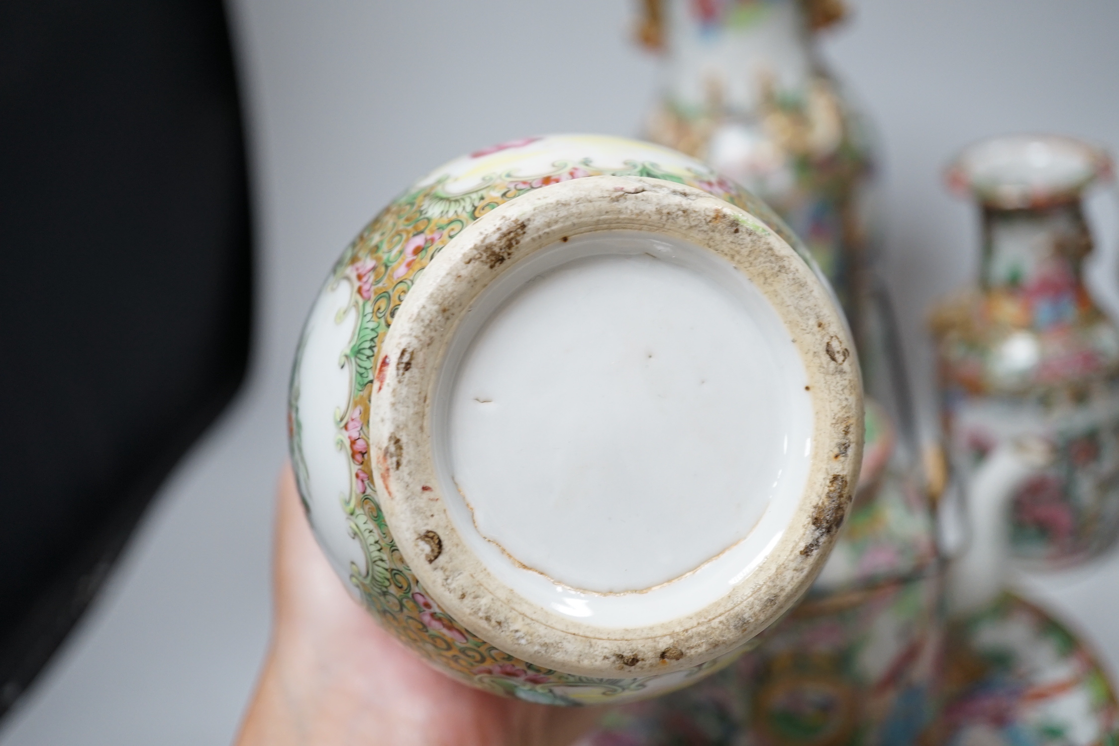 A collection of Chinese Cantonese famille rose vases, two teapots and a plate